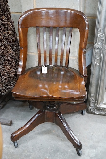 An early 20th century American walnut swivel desk chair by the Marble and Shattuck Chair Company, width 49cm, depth 44cm, height 86cm
